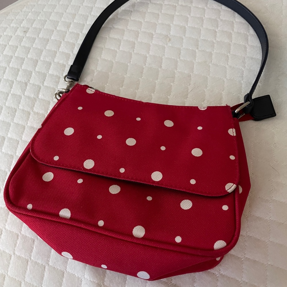 Red purse with white polka dots. Size: 7”x8” with 18” navy blue strap. Like new.